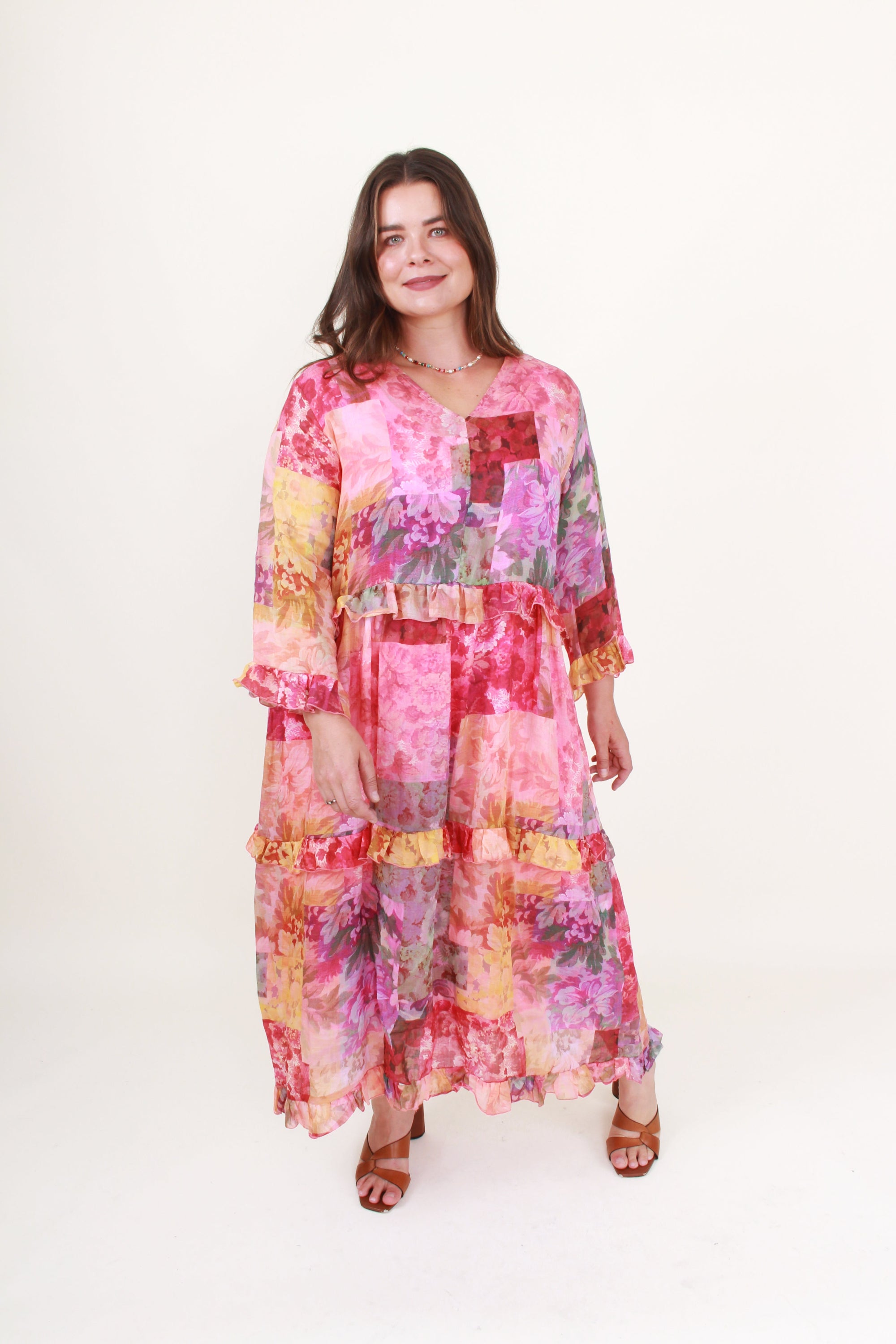 Woman wearing a colorful patchwork dress on a white background