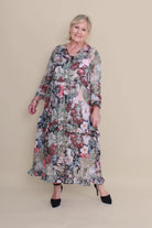 Woman wearing a floral dress against a beige background