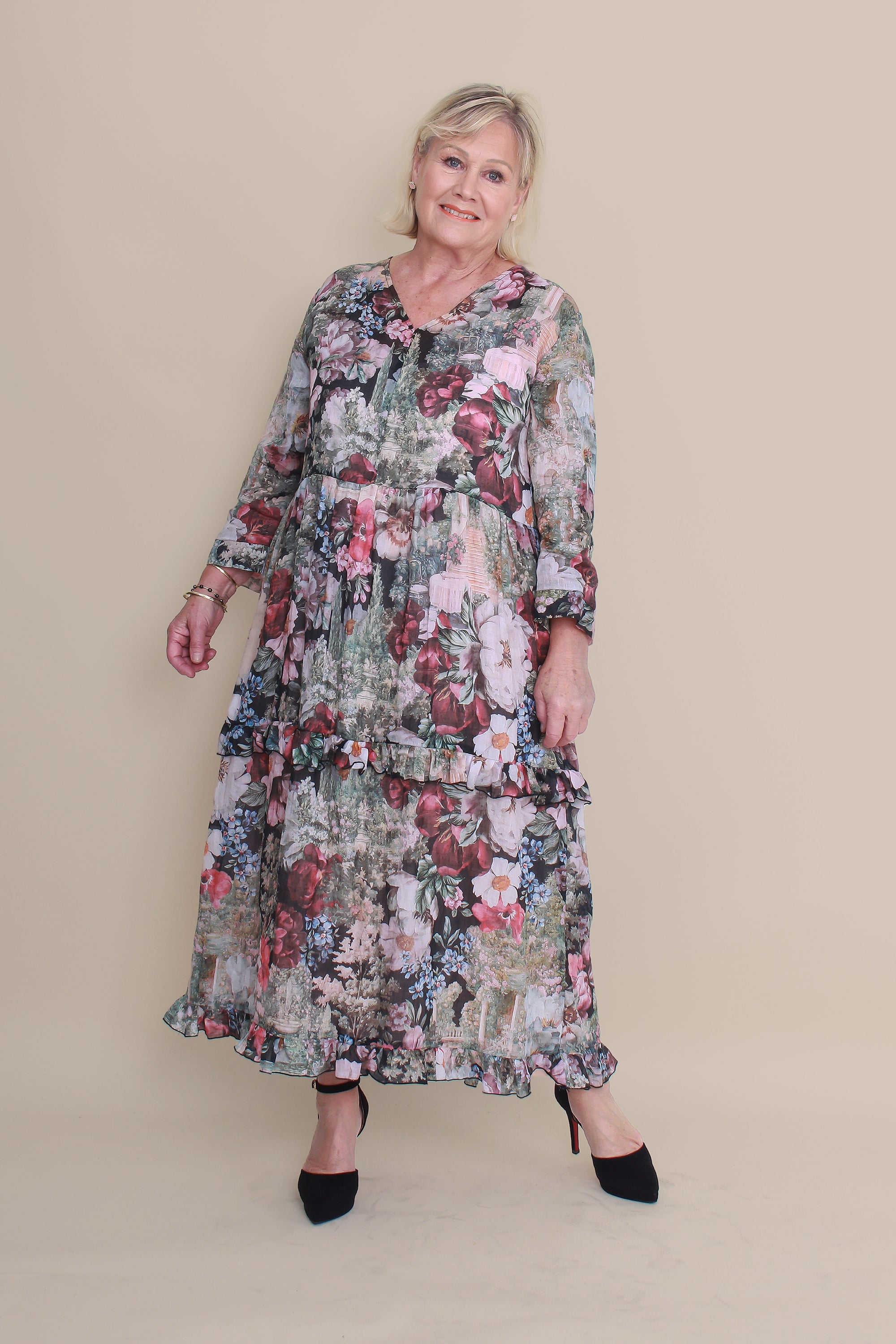 Woman wearing a floral dress against a beige background