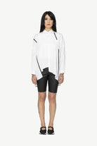 button through step hem shirt white with black details and black short worn by model 