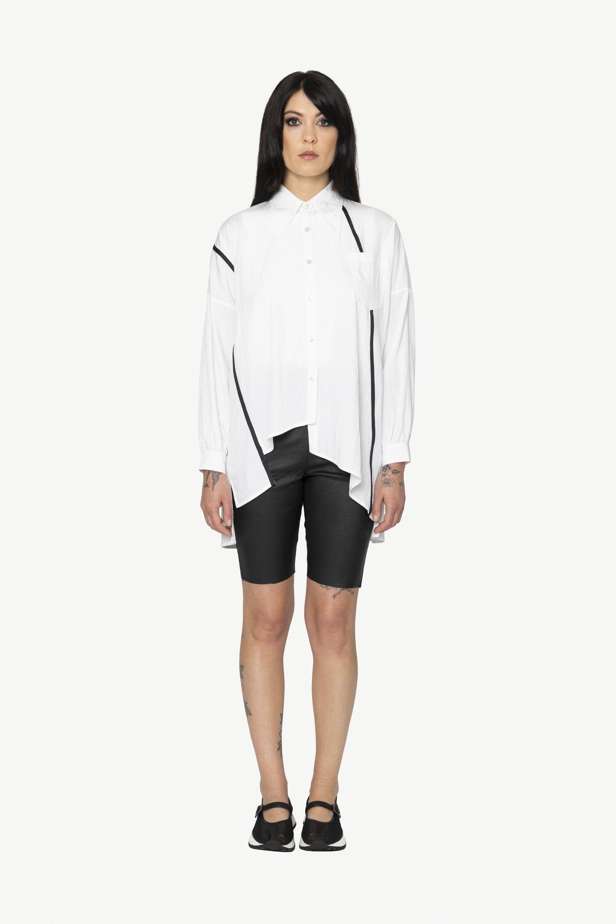 button through step hem shirt white with black details and black short worn by model 