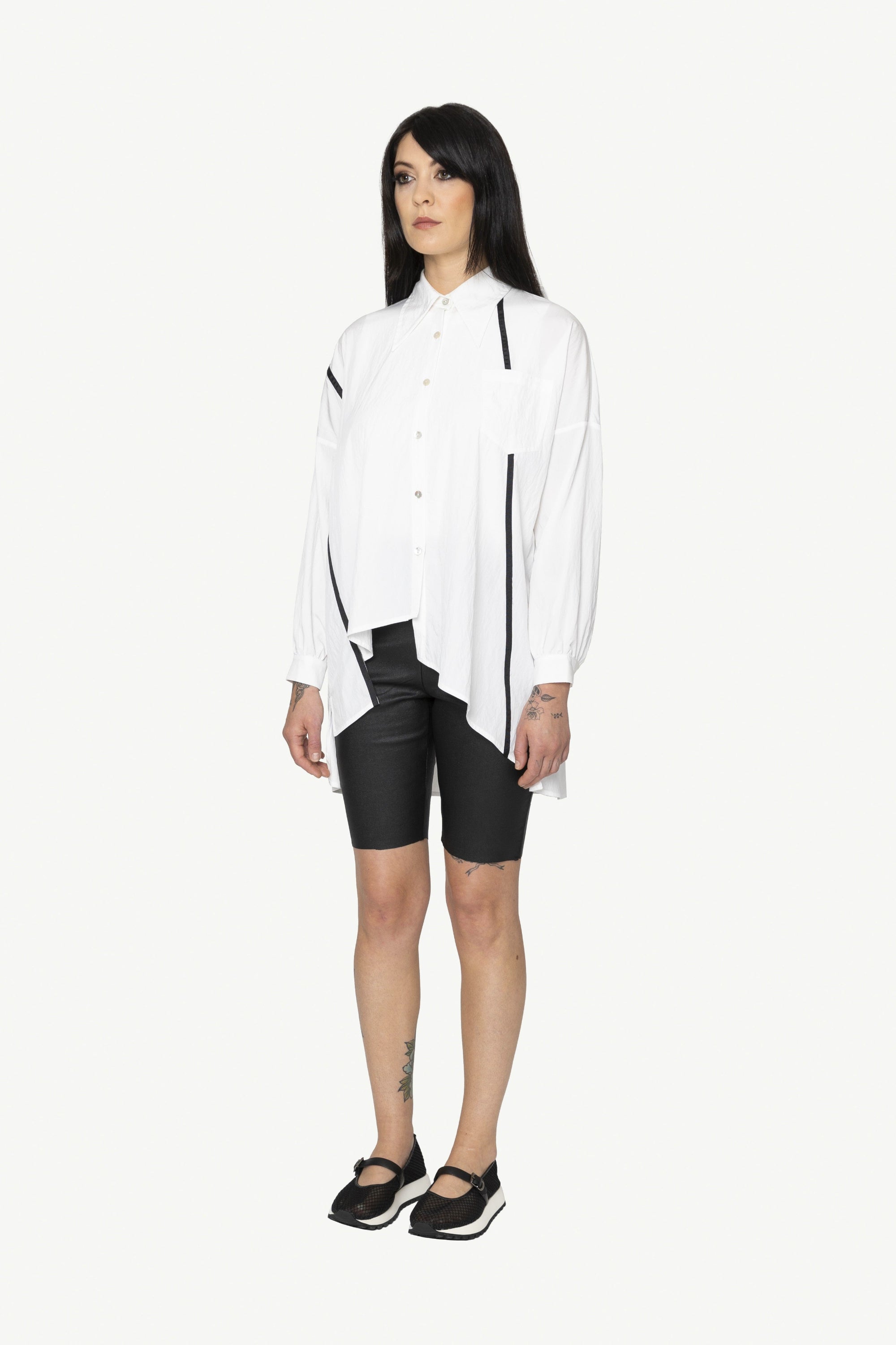 button through step hem shirt white with black details and black short worn by model 