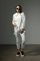 button through step hem shirt white with black details and white pant worn by model 
