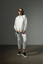 button through step hem shirt white with black details and white pant worn by model 