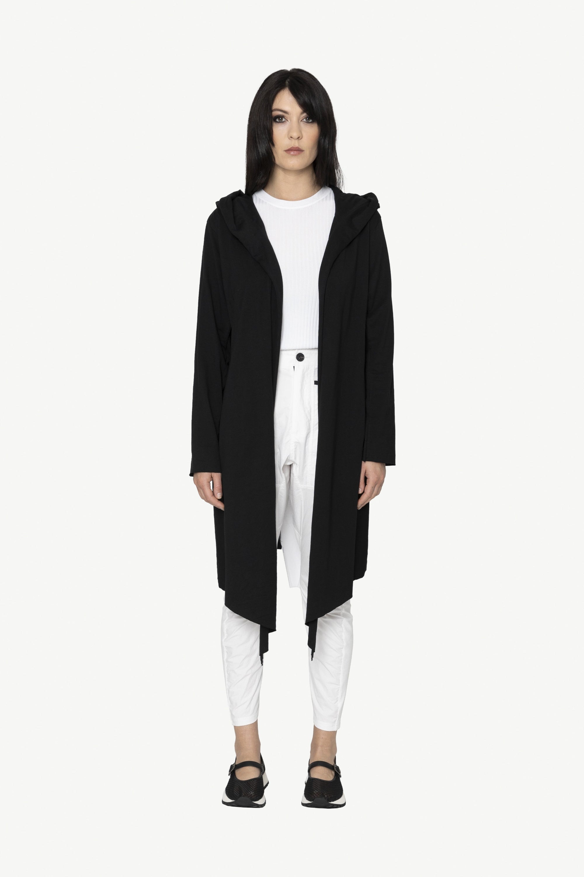 black longline jacket over white outfit worn by model 