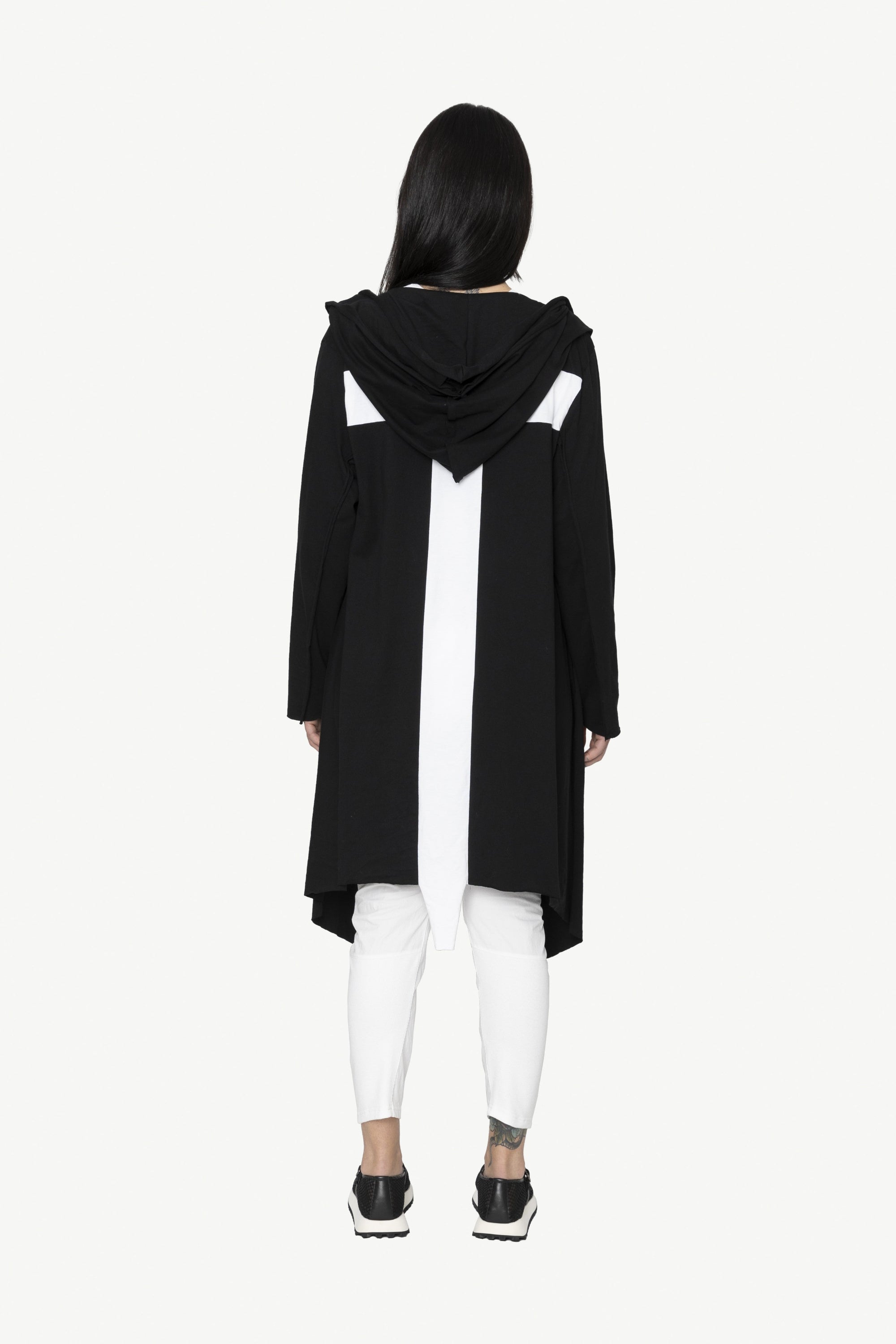 black longline jacket over white outfit worn by model cross back