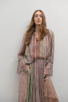 women wering a multicoloured shimmery blouse and skirt on a white backdrop