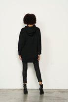 womens longline long sleeve hoodie in black worn by model back view