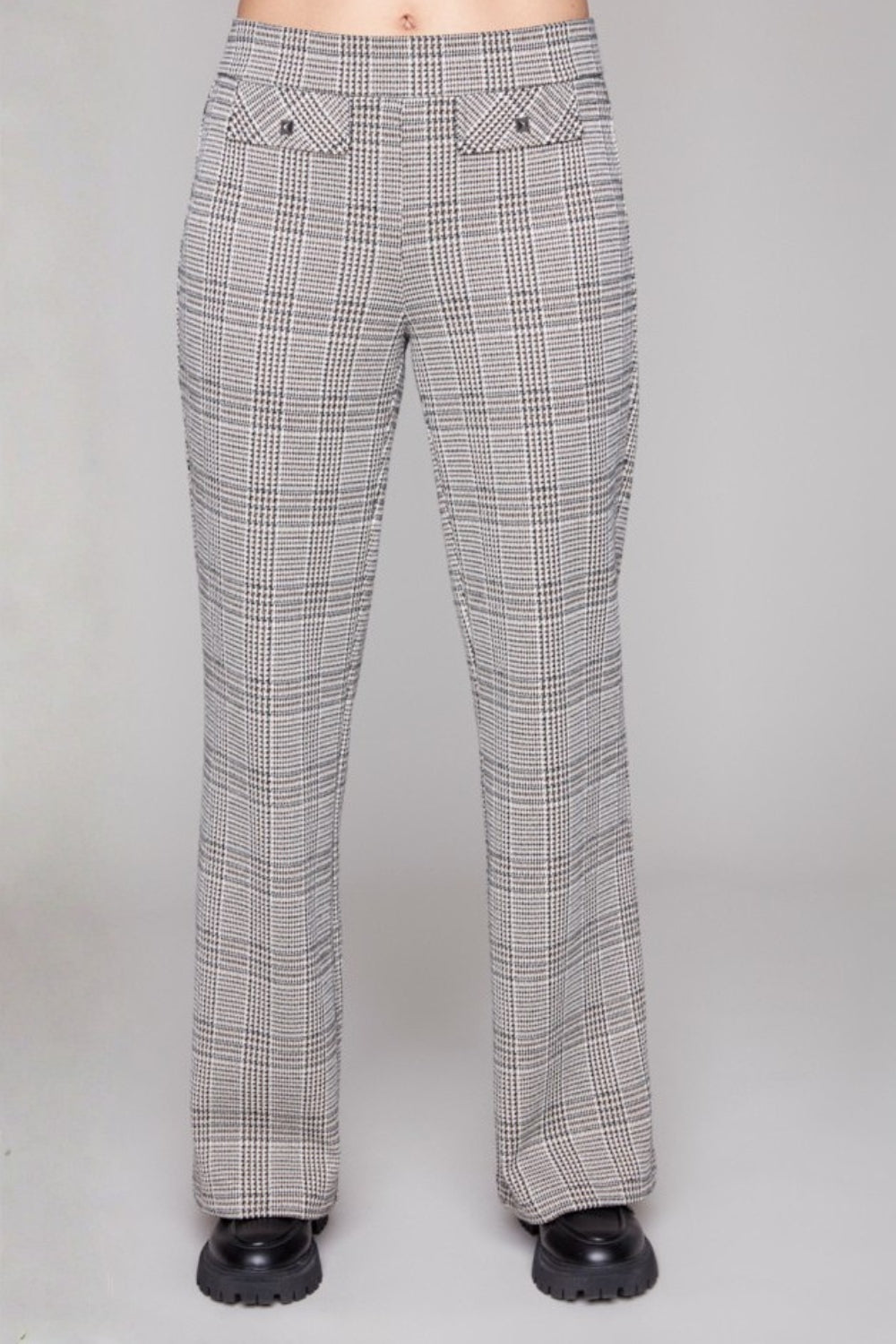 Plaid pants worn by a person on a grey background