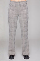 Plaid pants worn by a person on a grey background