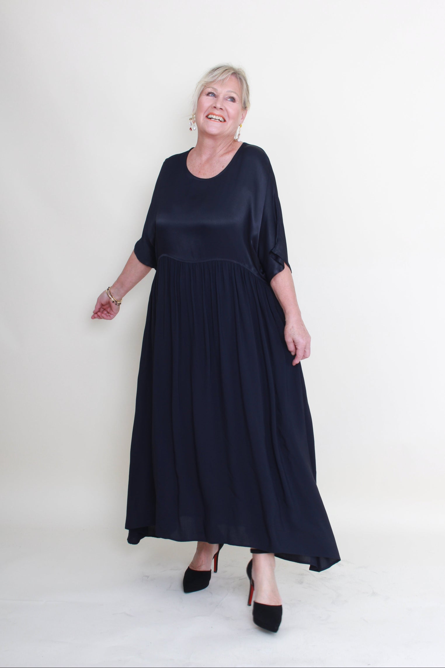 Woman wearing a navy blue dress on a white background