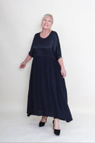 Woman wearing a navy blue dress on a white background