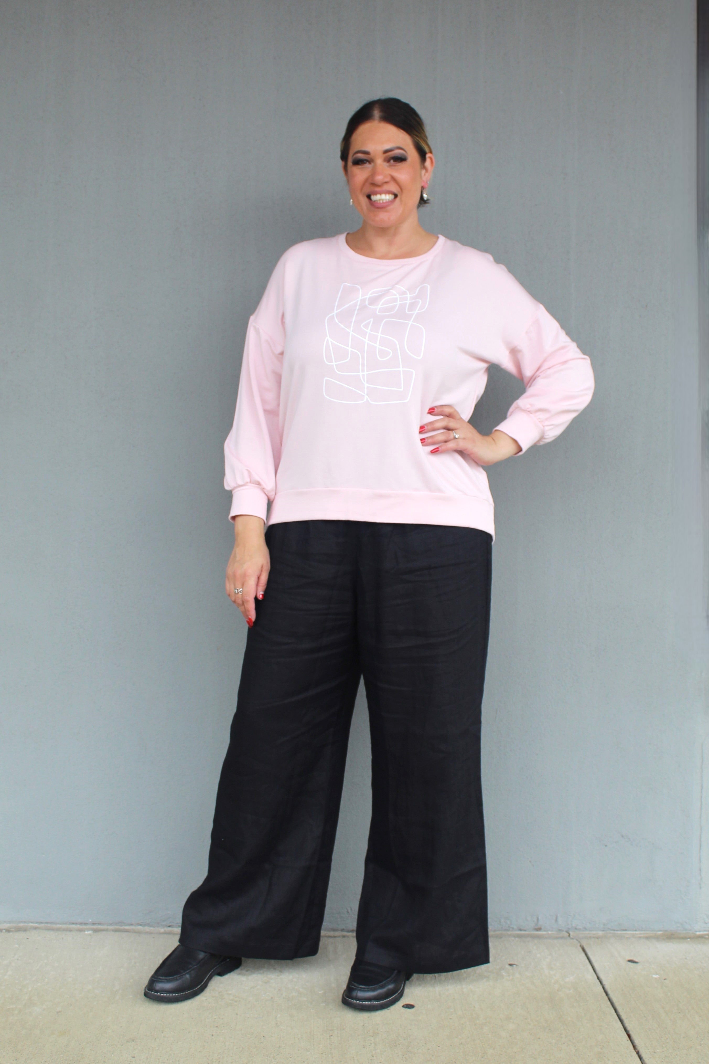 womens cocoon linen pant in black with blush sweater worn by model