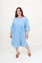 Woman wearing a light blue dress on a white background