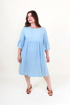 Woman wearing a light blue dress on a white background