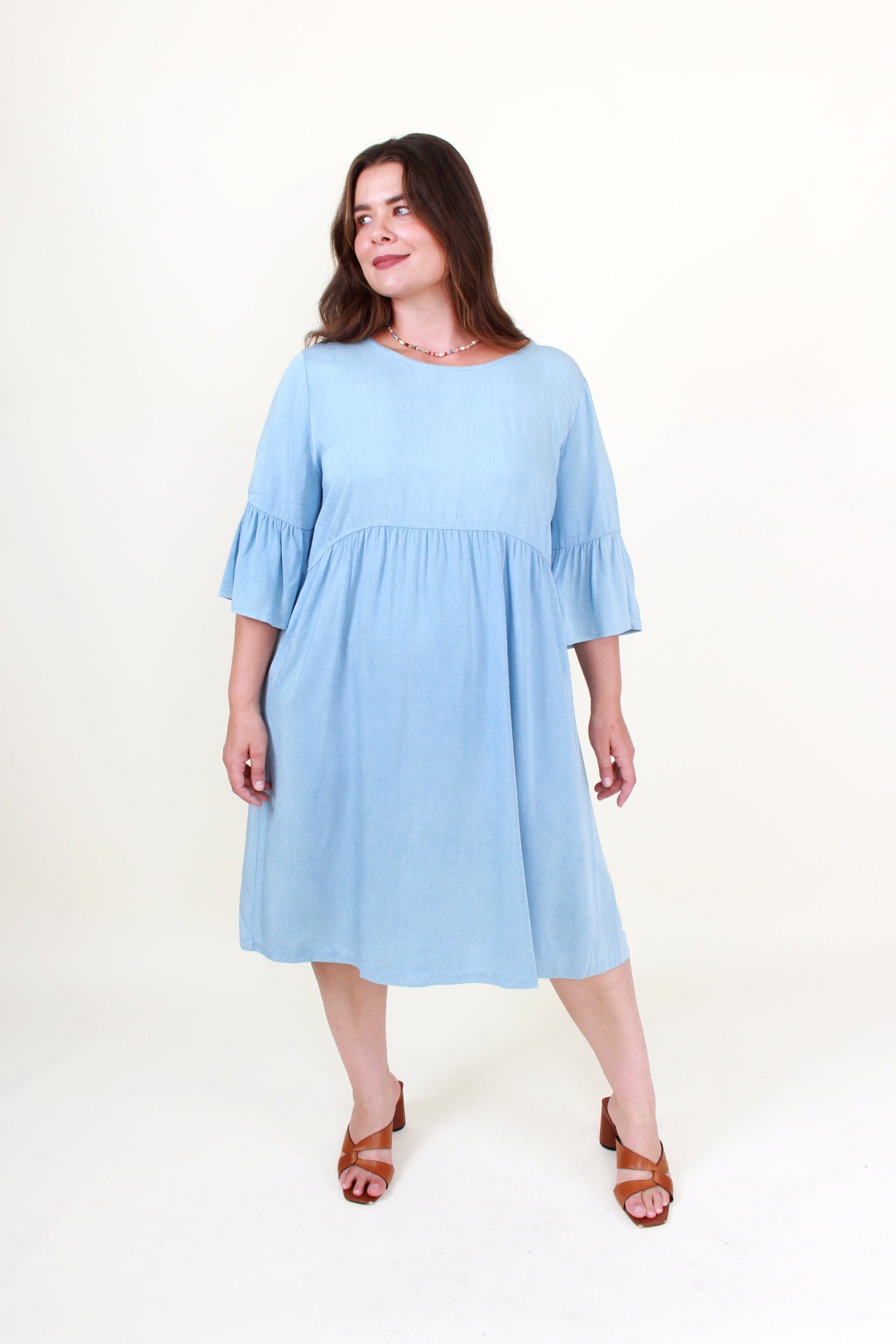 Woman wearing a light blue dress on a white background