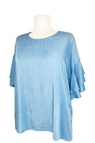 Blue top on a mannequin against a white background