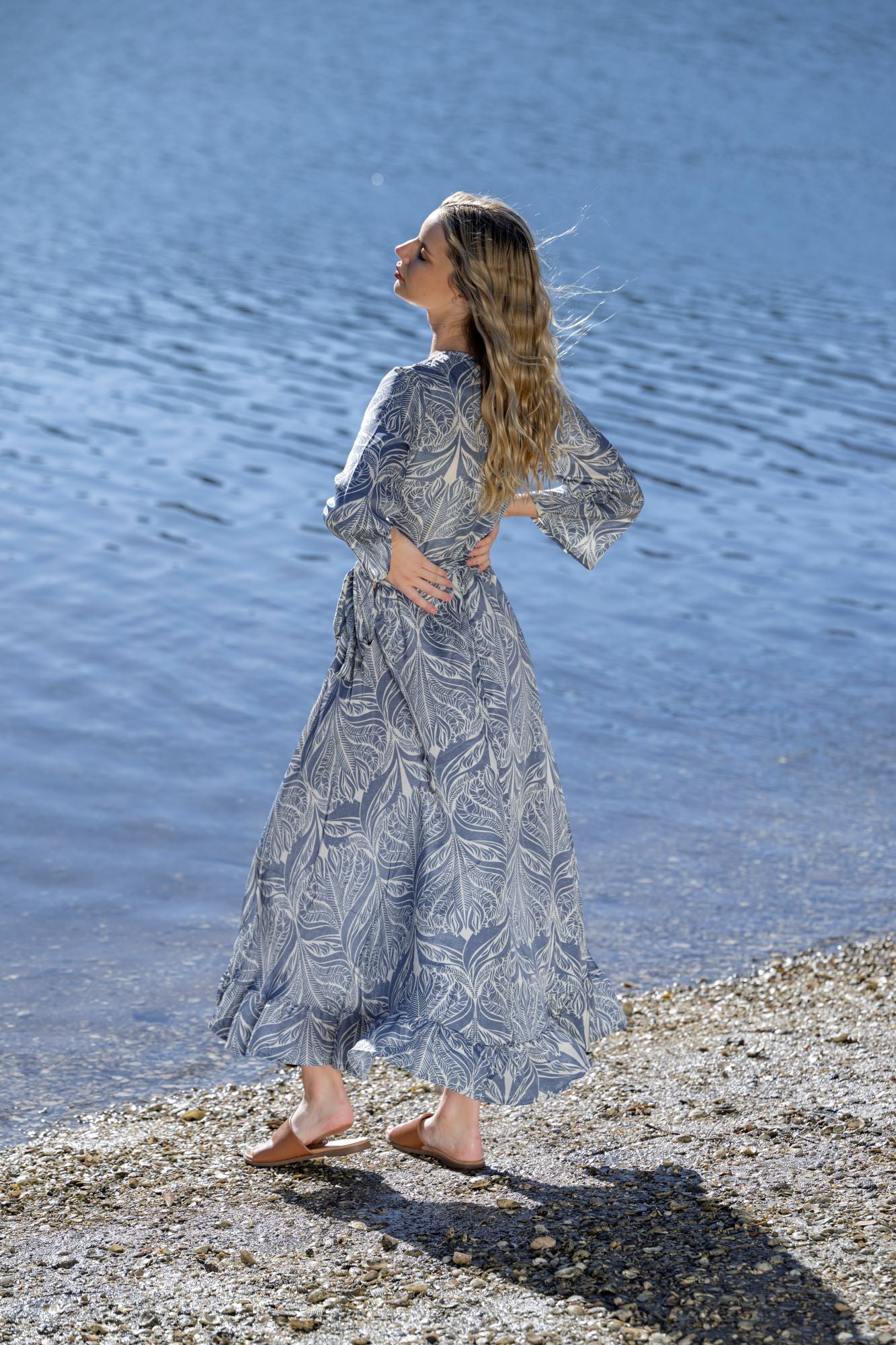 midi wrap dress blue cream print worn by model lake background back view