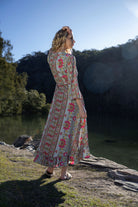 long sleeve boho print maxi wrap dress worn by model outdoors back view