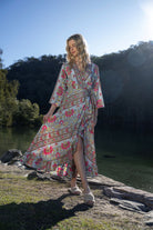 long sleeve boho print maxi wrap dress worn by model outdoors 