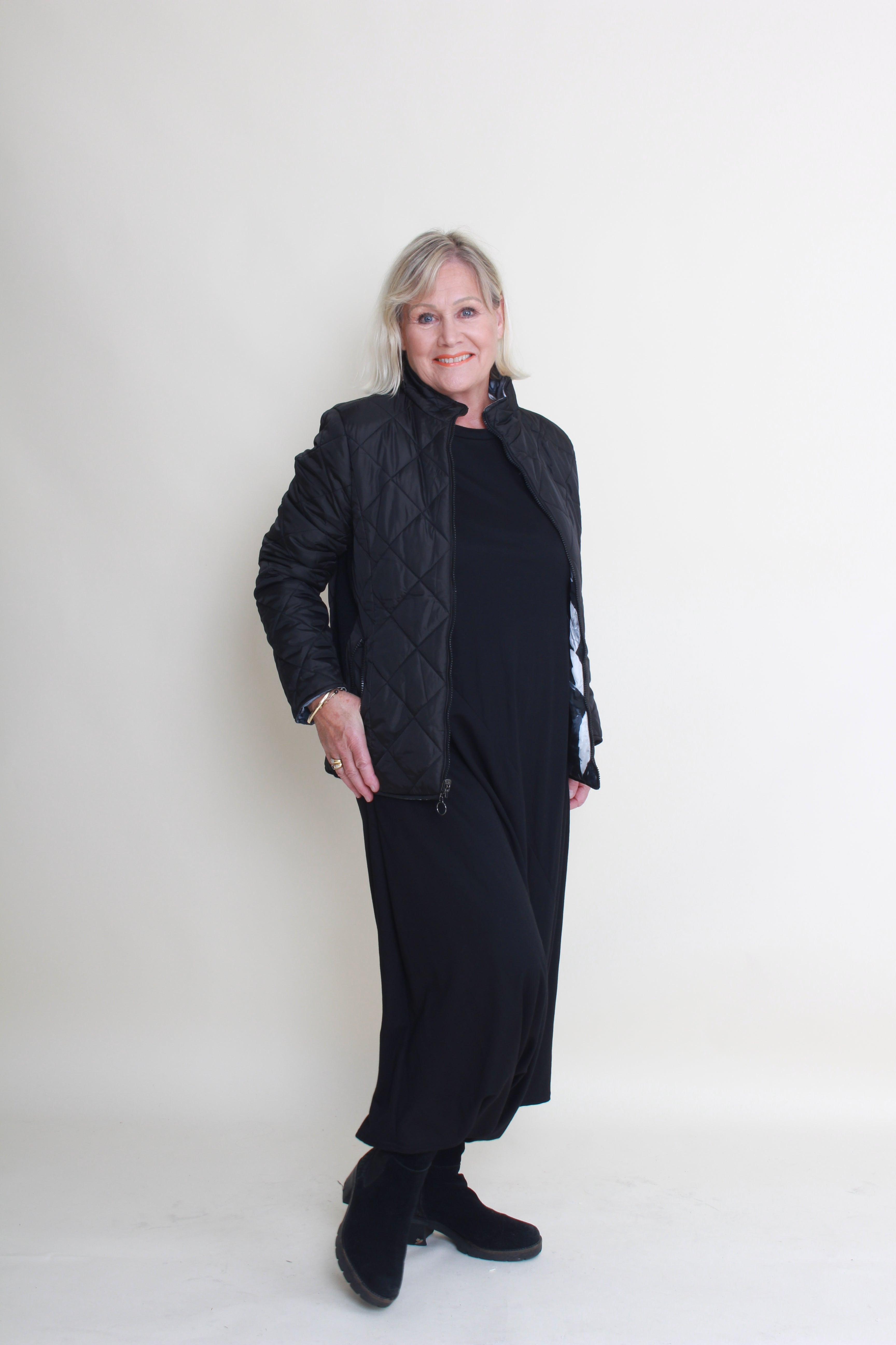 Person wearing a black coat on a white background
