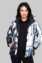 Person wearing a black and white patterned jacket on a white background