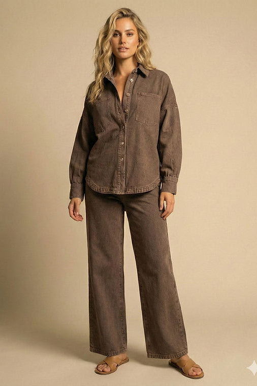 A woman modeling a matching two-piece lounge set consisting of a brown button-down shirt and wide-leg pants, styled with brown sandals against a solid beige studio background.