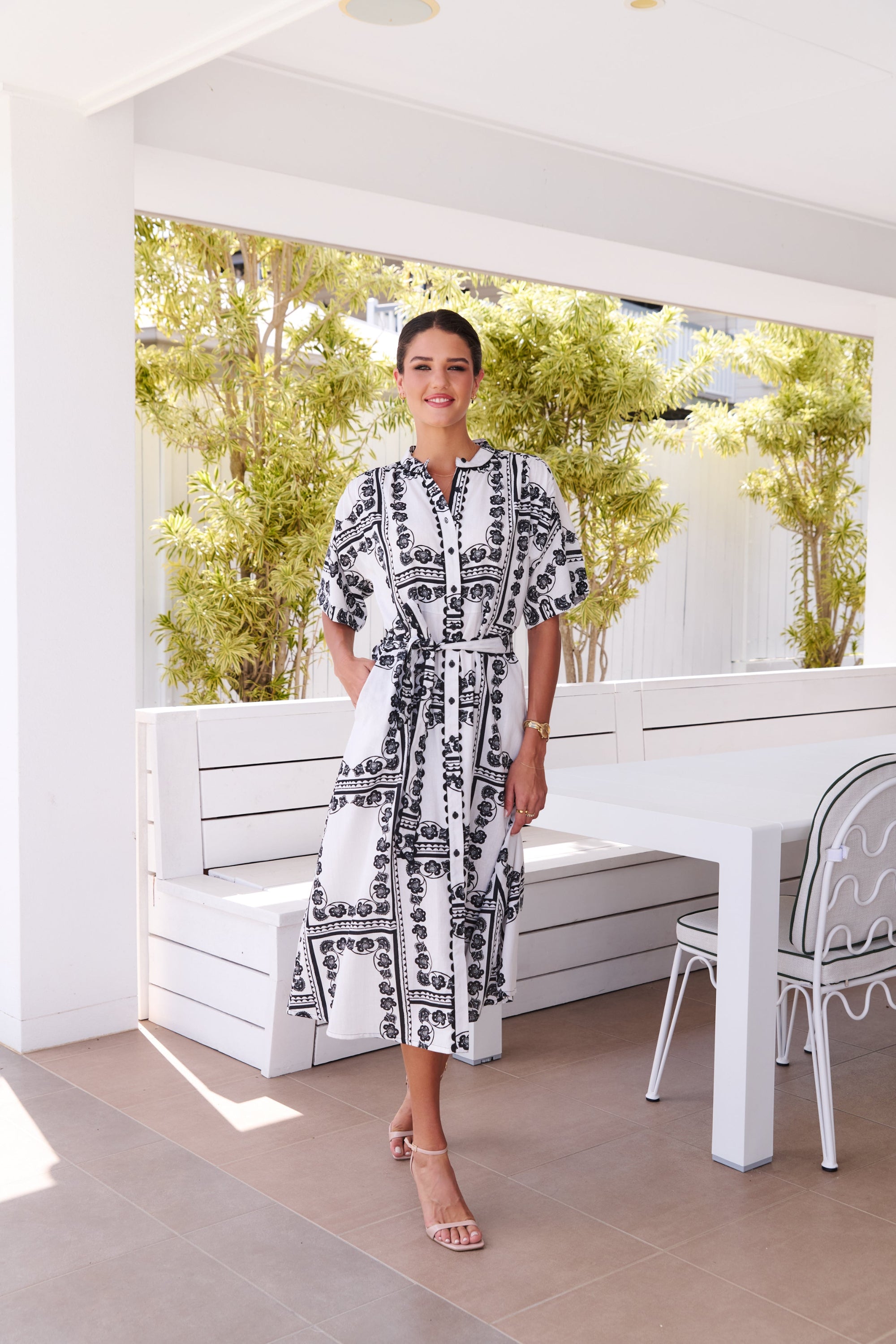 womens midi dress white with black print worn by model outdoors