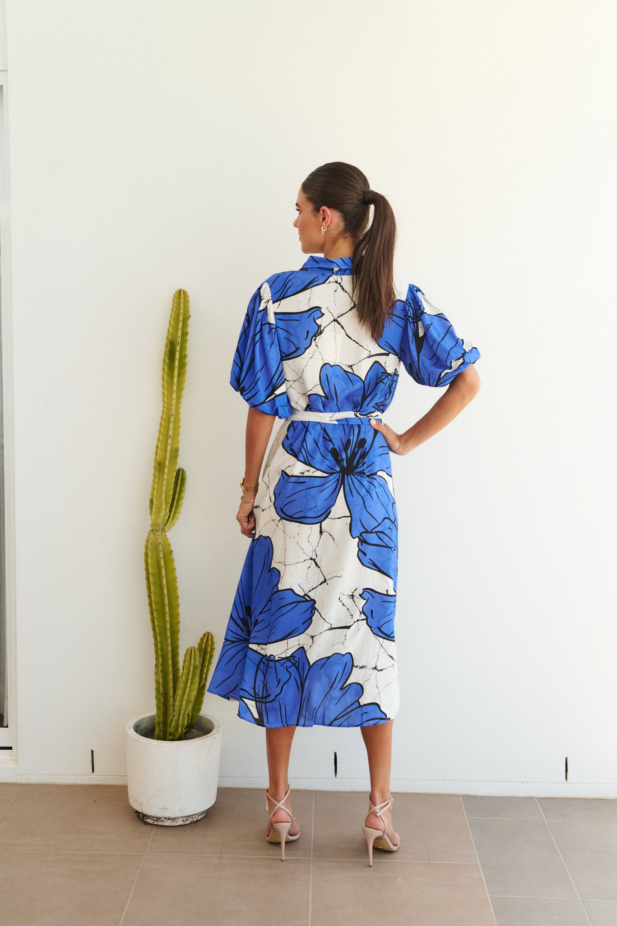 white blue large floral midi dress worn by model back view