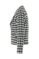 Houndstooth patterned coat on a white background side angle