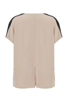 A beige short-sleeve top shown from the back, featuring black contrast panels along the shoulders and a central back slit.