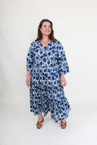 Woman wearing a blue floral dress on a white background