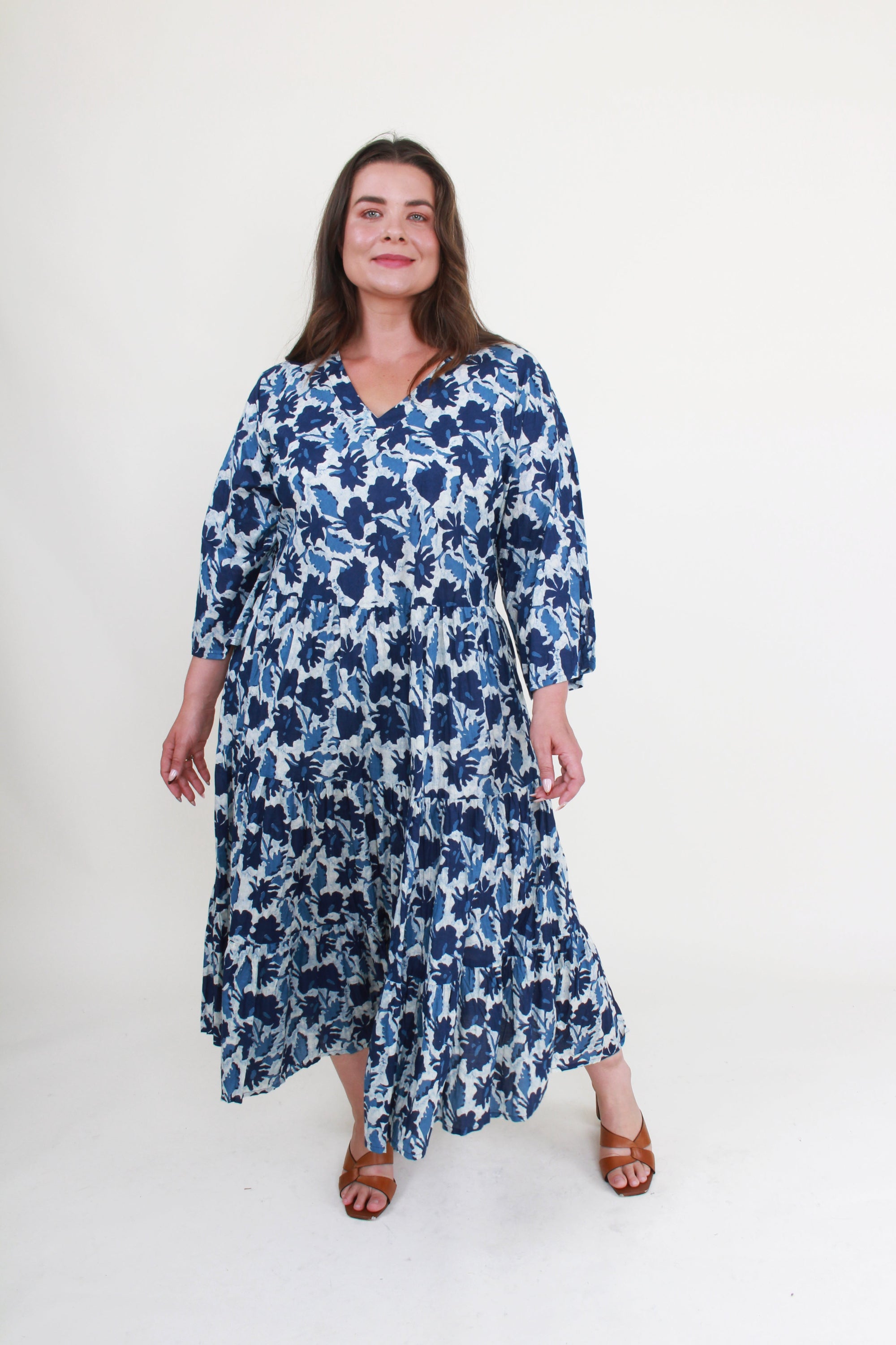 Woman wearing a blue floral dress on a white background
