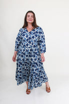 Woman wearing a blue floral dress on a white background