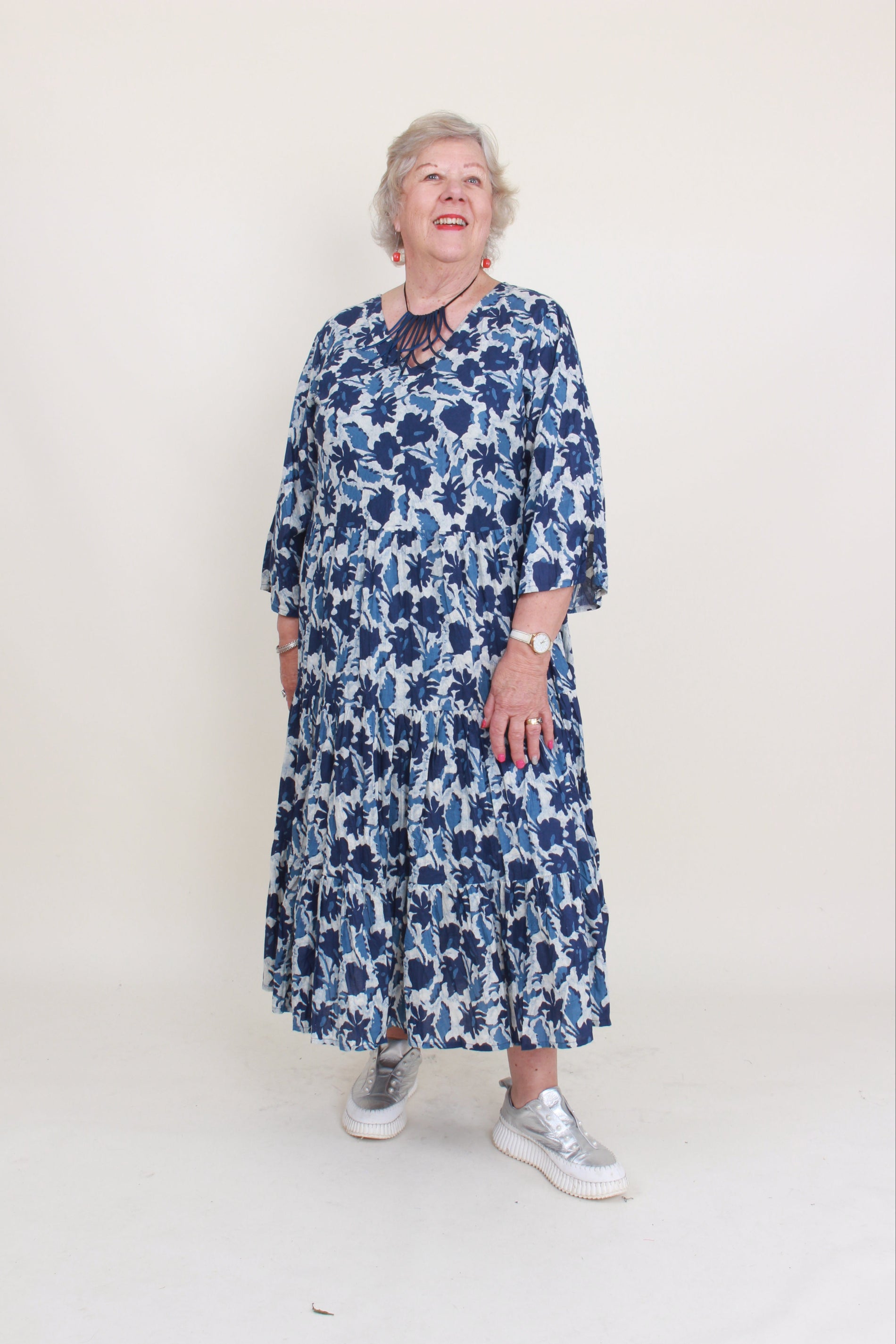 women wearing a blue floral dress on a plain background