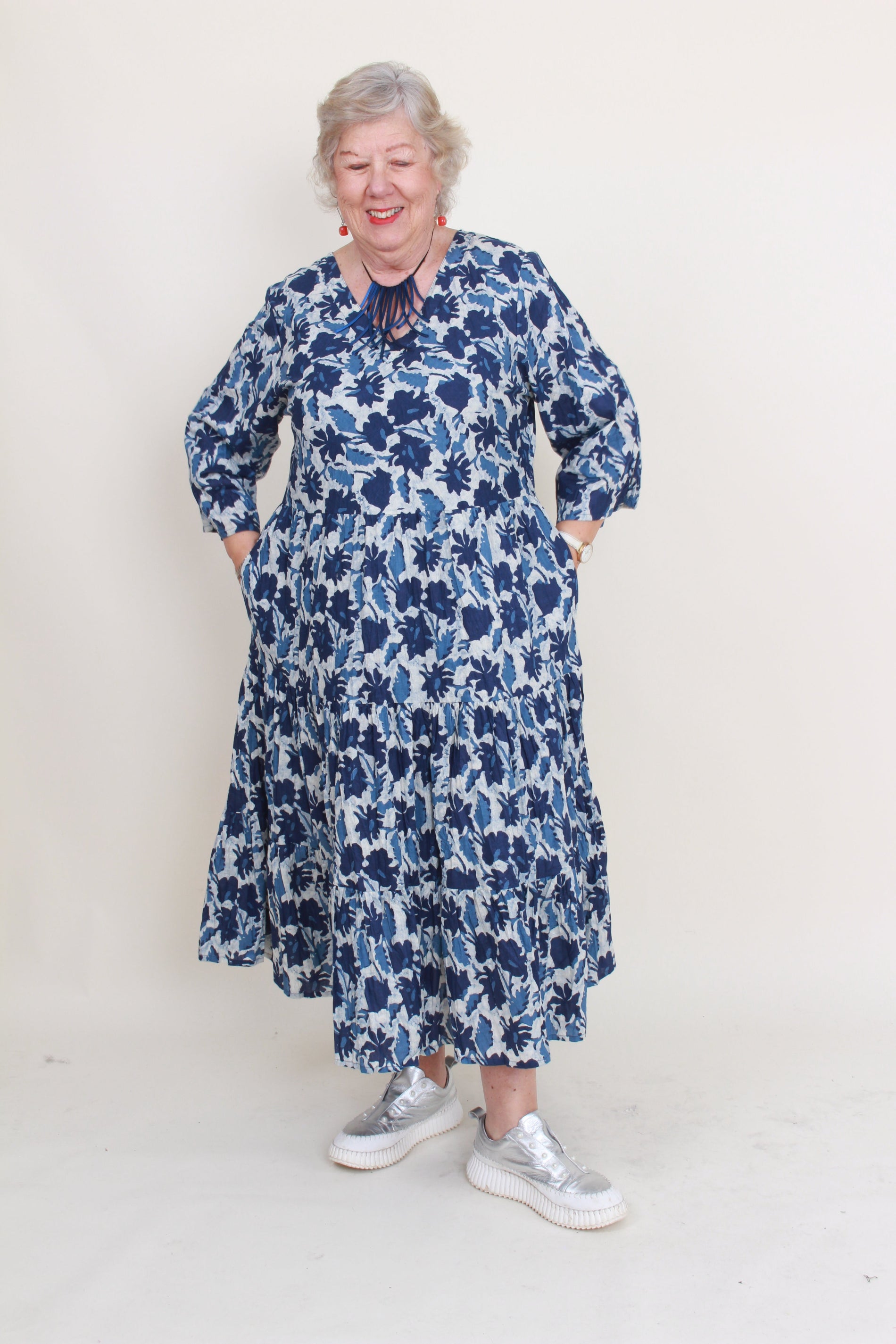 women wearing blue floral dress on plain background