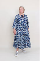 women wearing a blue floral dress on a plain background