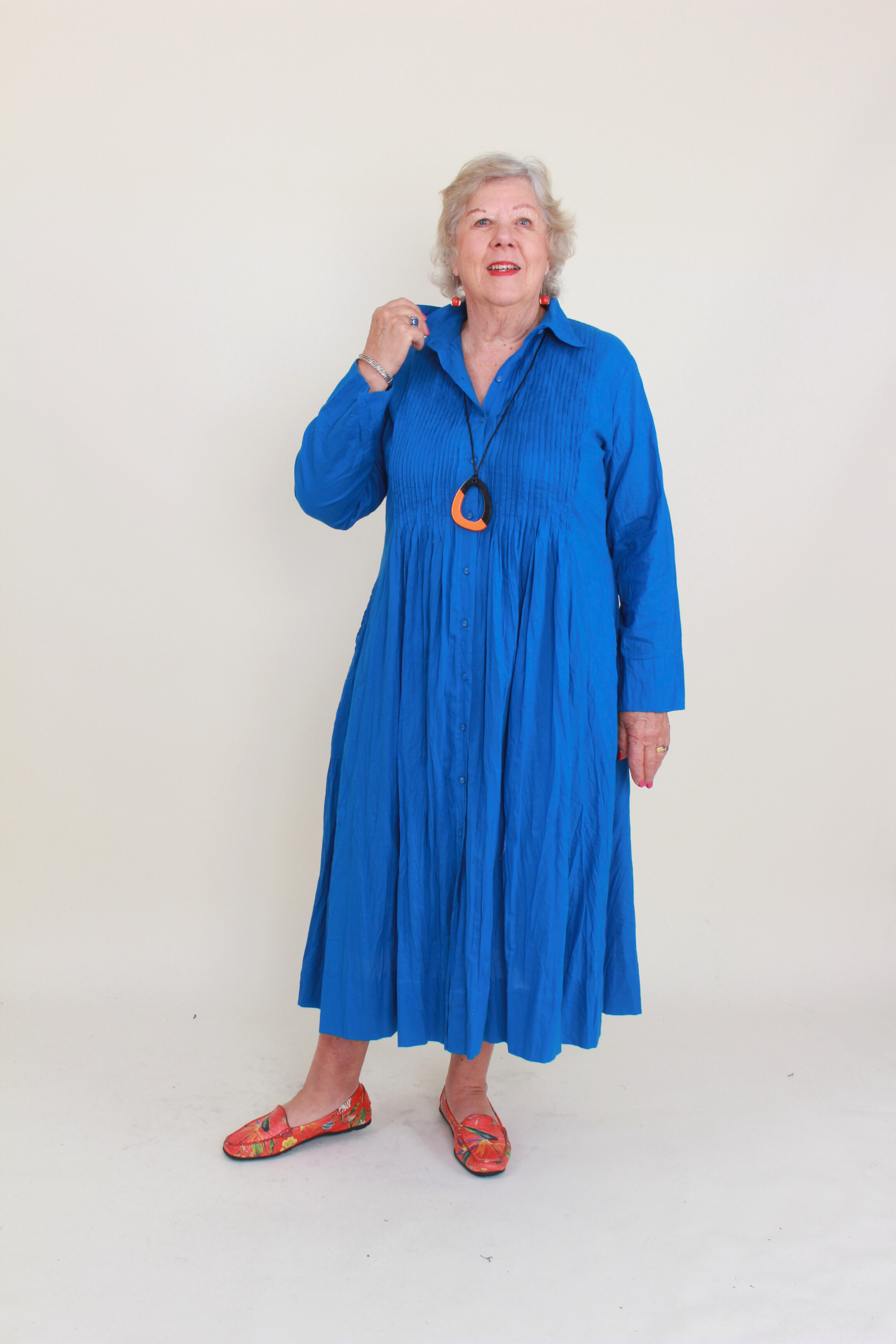 Woman wearing a blue dress with a white background