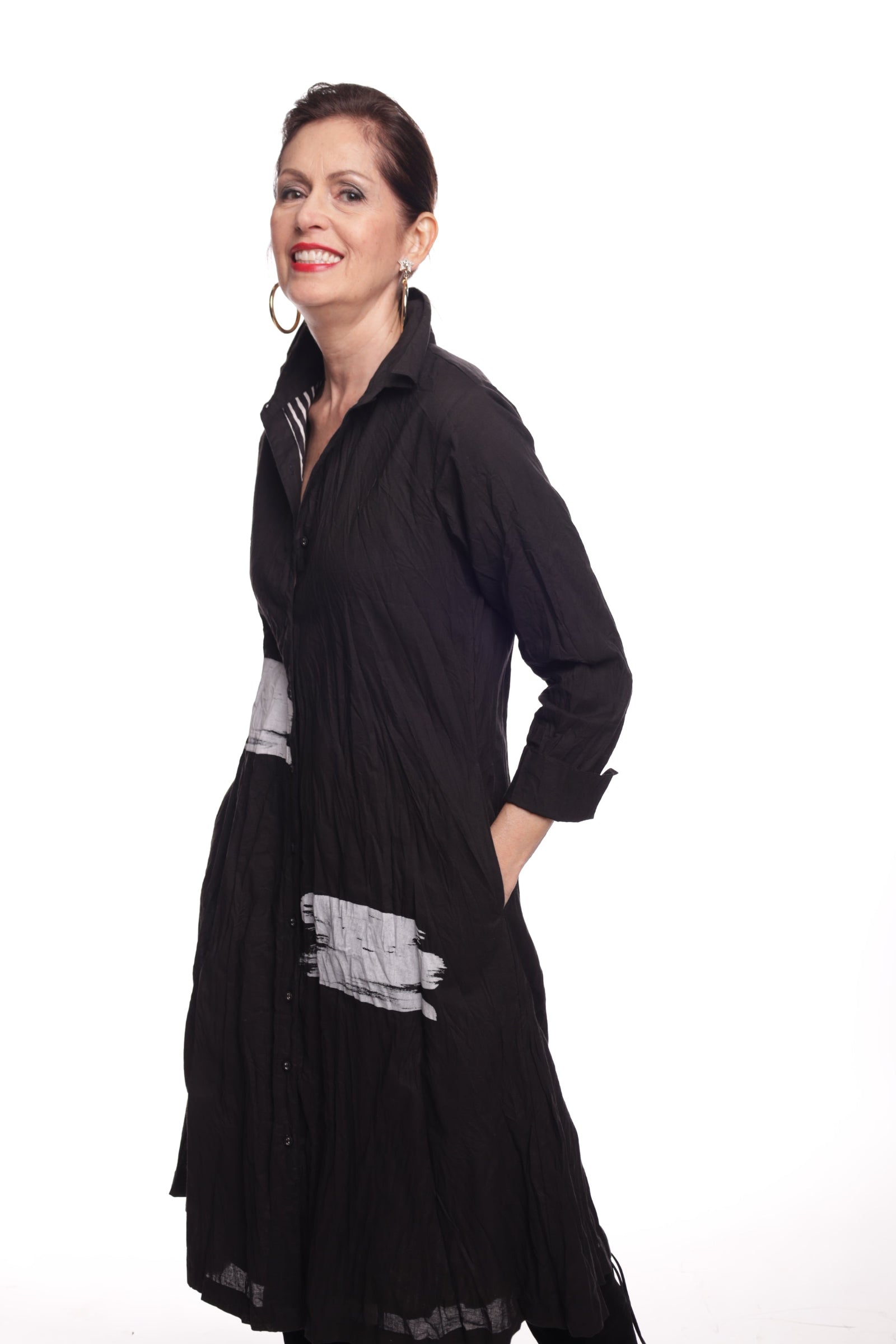 Person wearing a black outfit with white patterns on a white background