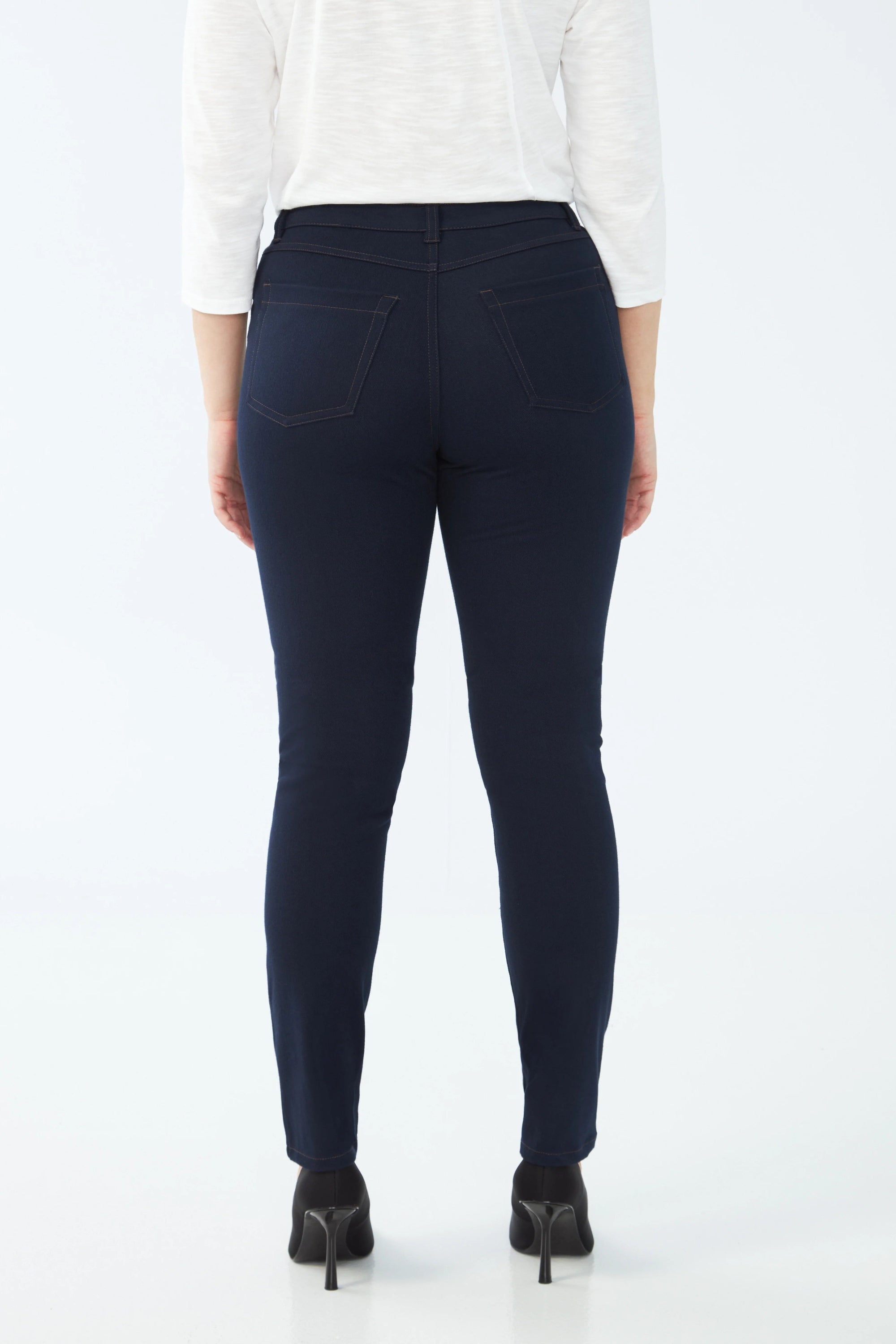 dark wash slim jean worn by model back view