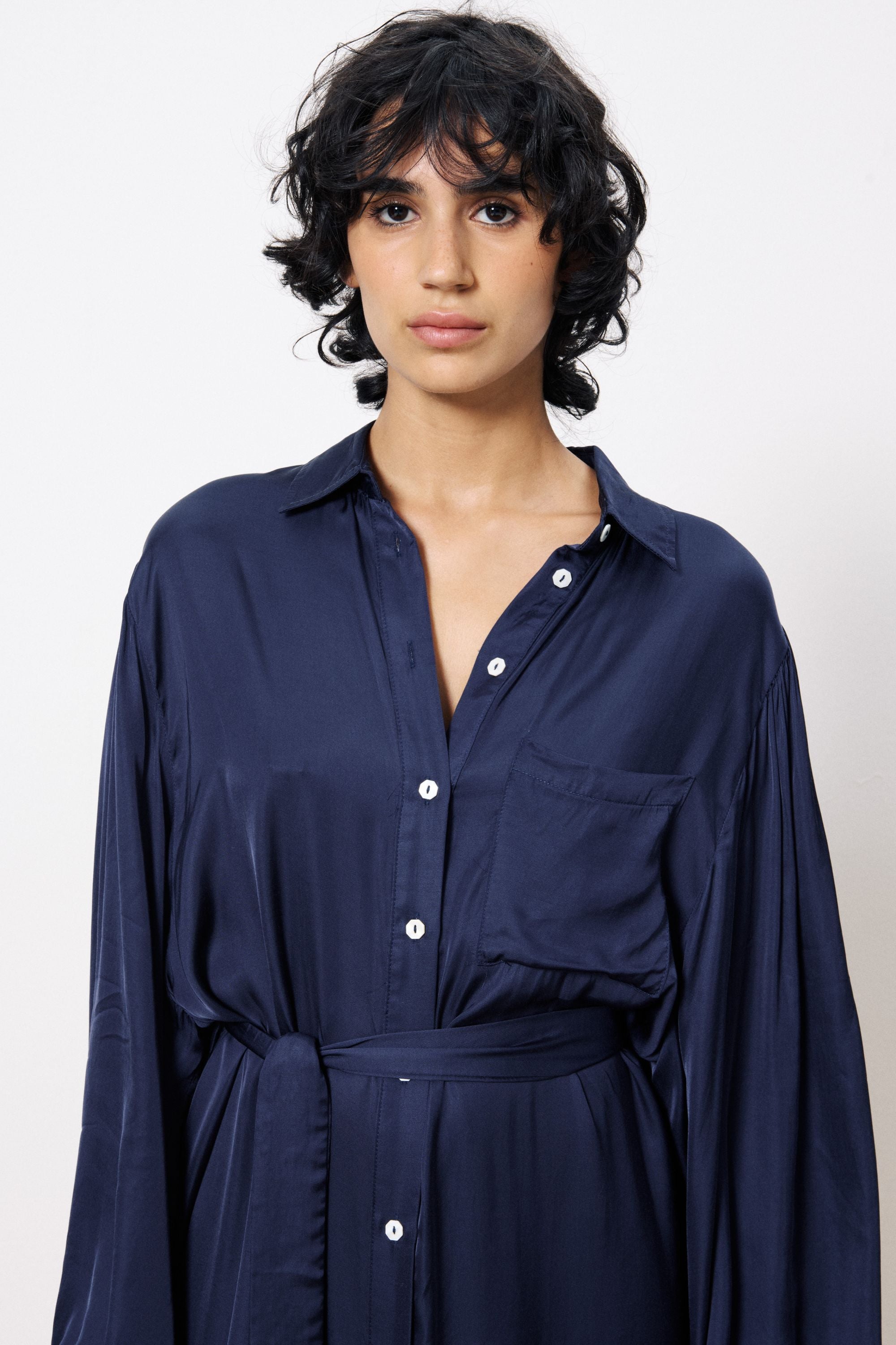 navy blue satin button through midi dress worn by model close up