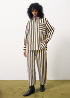 Person wearing a brown and white striped outfit on a plain background