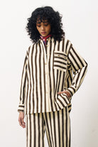 Person wearing a brown and white striped outfit on a white background