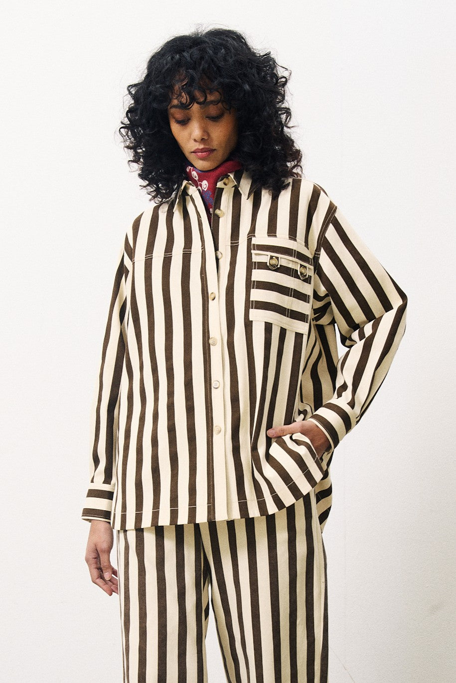 Person wearing a brown and white striped outfit on a white background