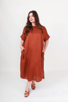 Woman wearing a brown dress on a white background