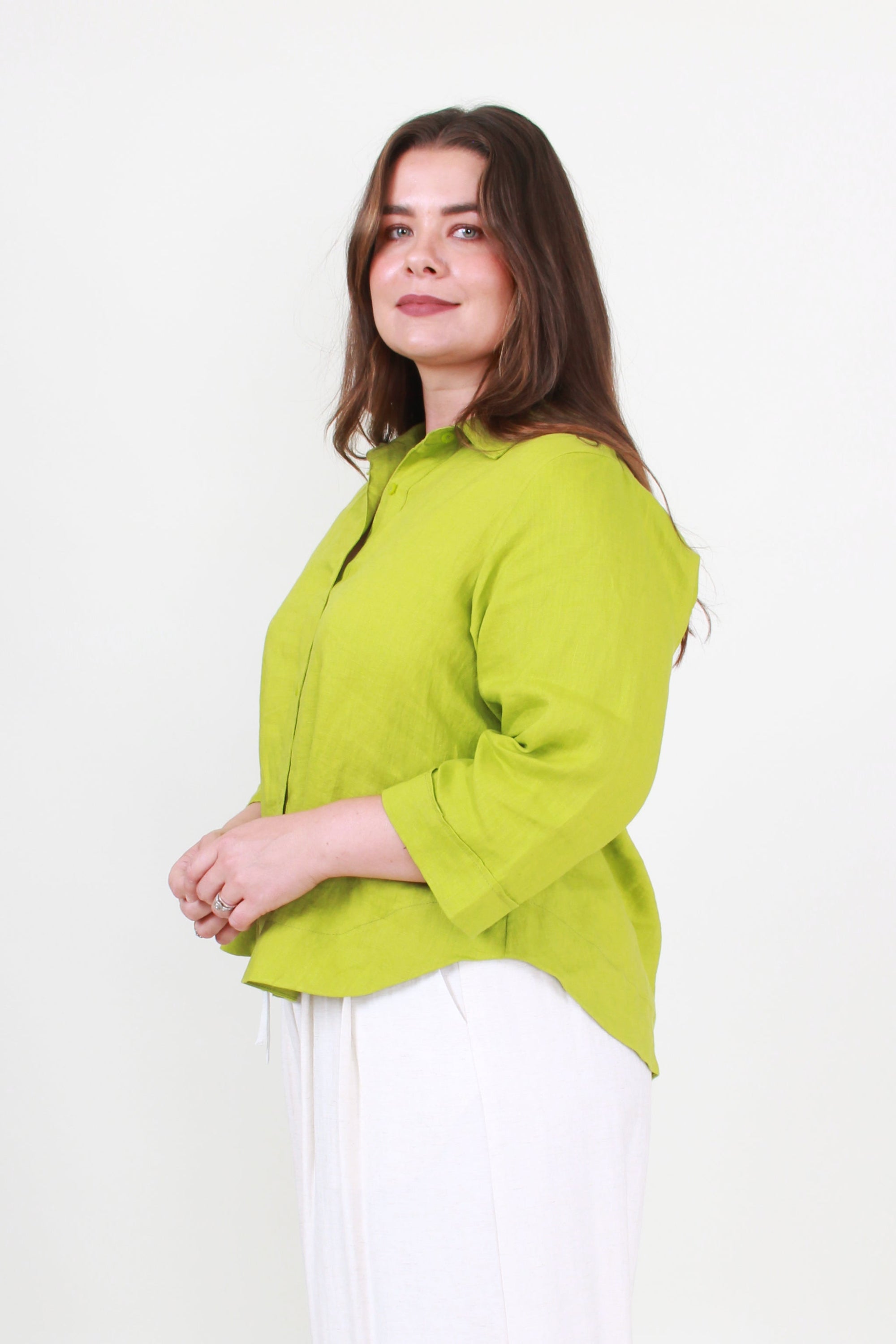 Woman wearing a green blouse against a white background