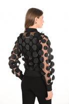 Black sheer jacket with circular patterns on a white background back angle