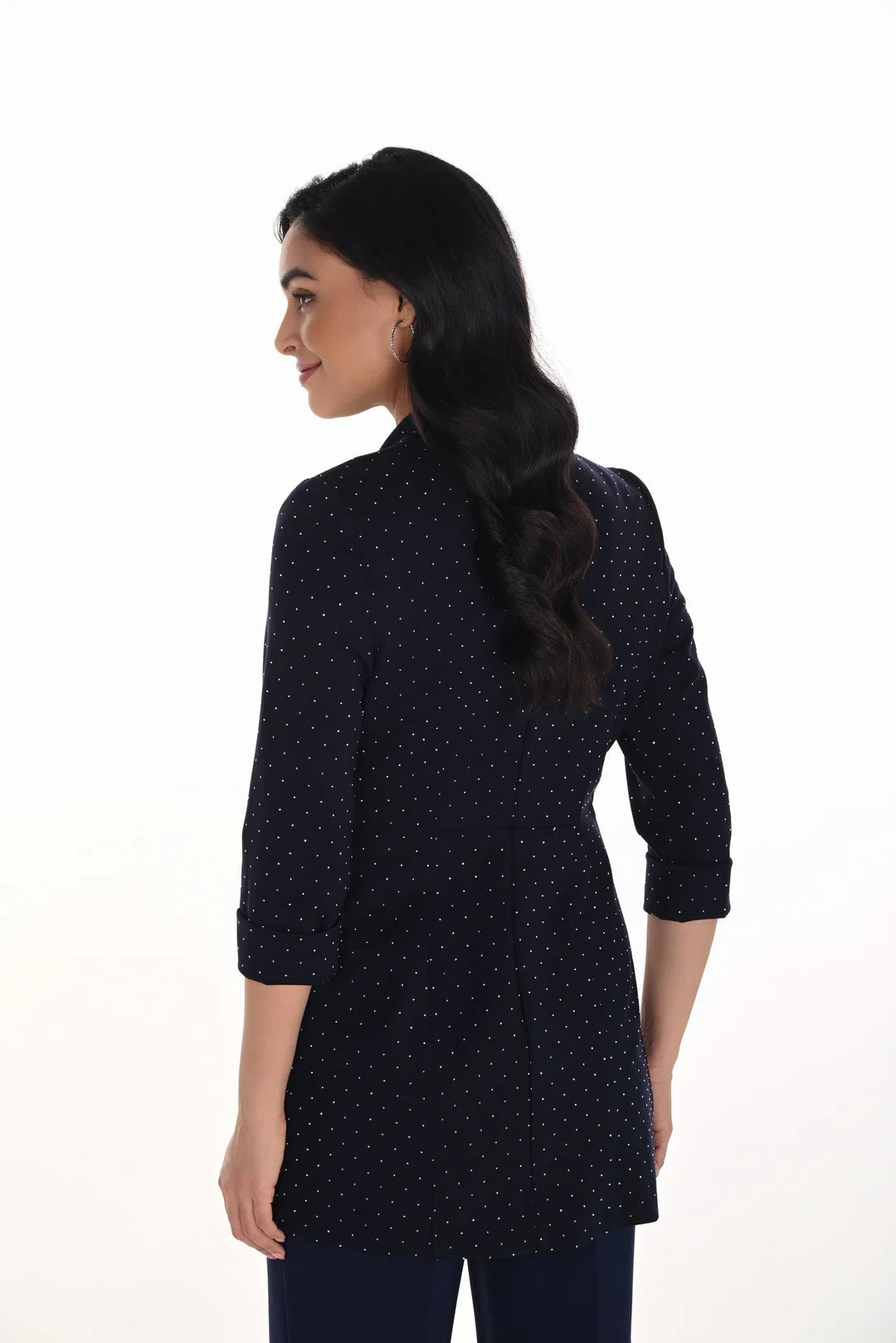 Woman wearing a navy blue diamante blazer on a white background back angle