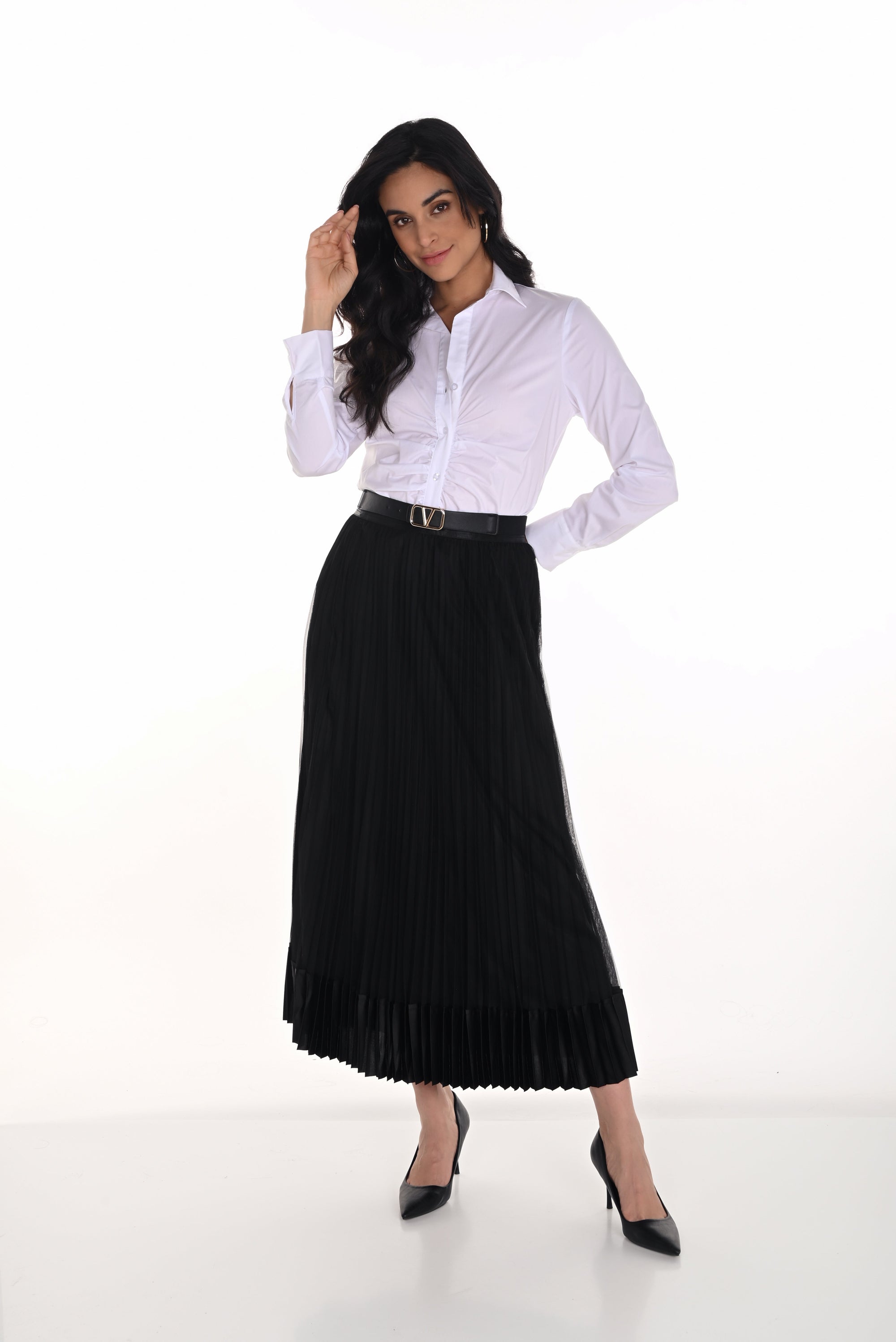 Woman wearing a white blouse and black pleated skirt on a white background