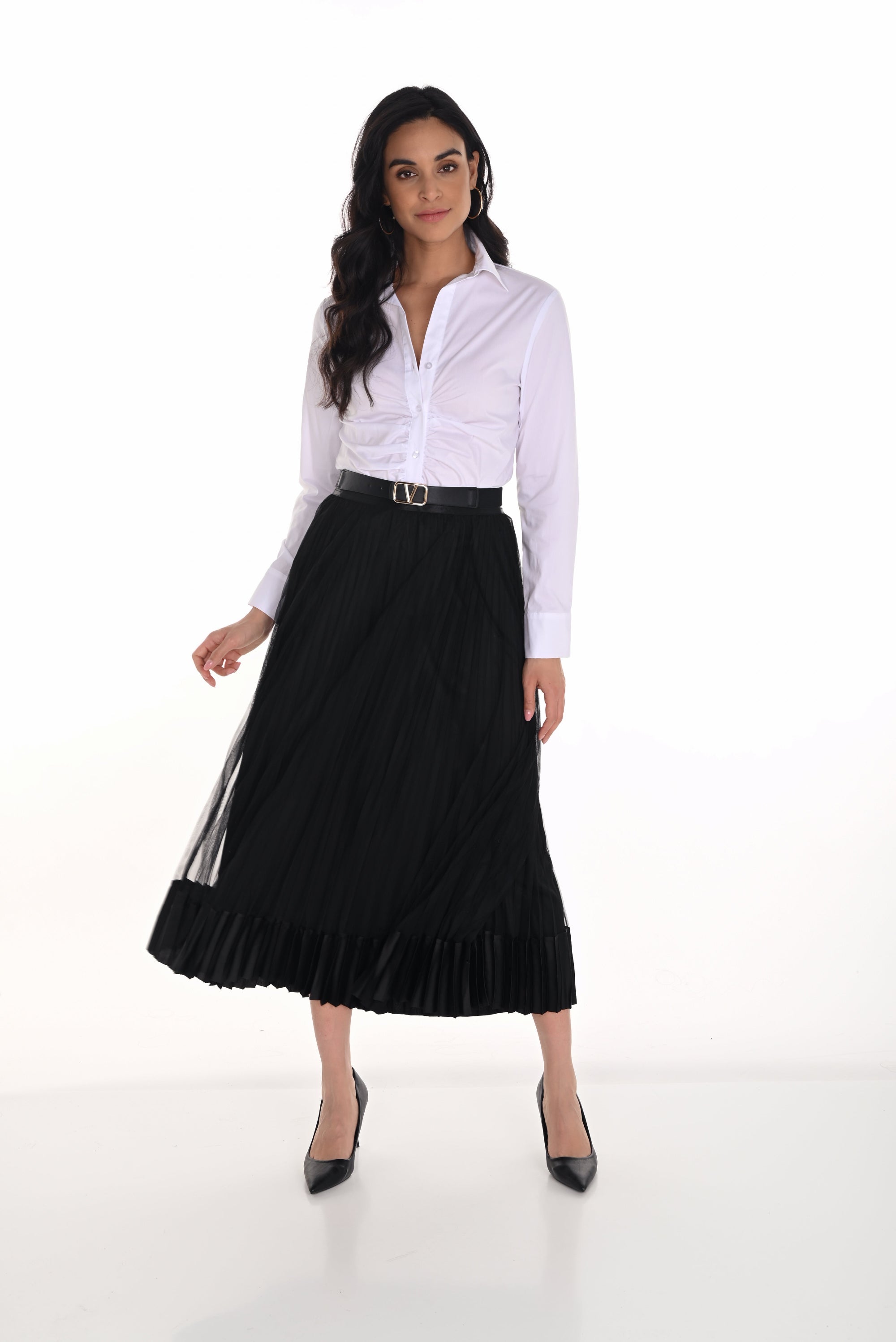 Woman wearing a white blouse and black pleated skirt on a white background